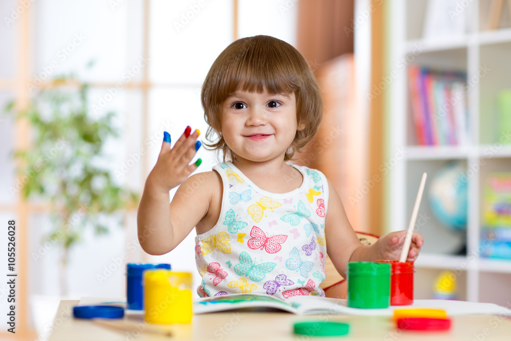 Happy child girl with hand painted color paints Happy child girl with hand painted color paints