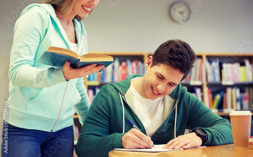Obraz na plátně happy students preparing to exams in library