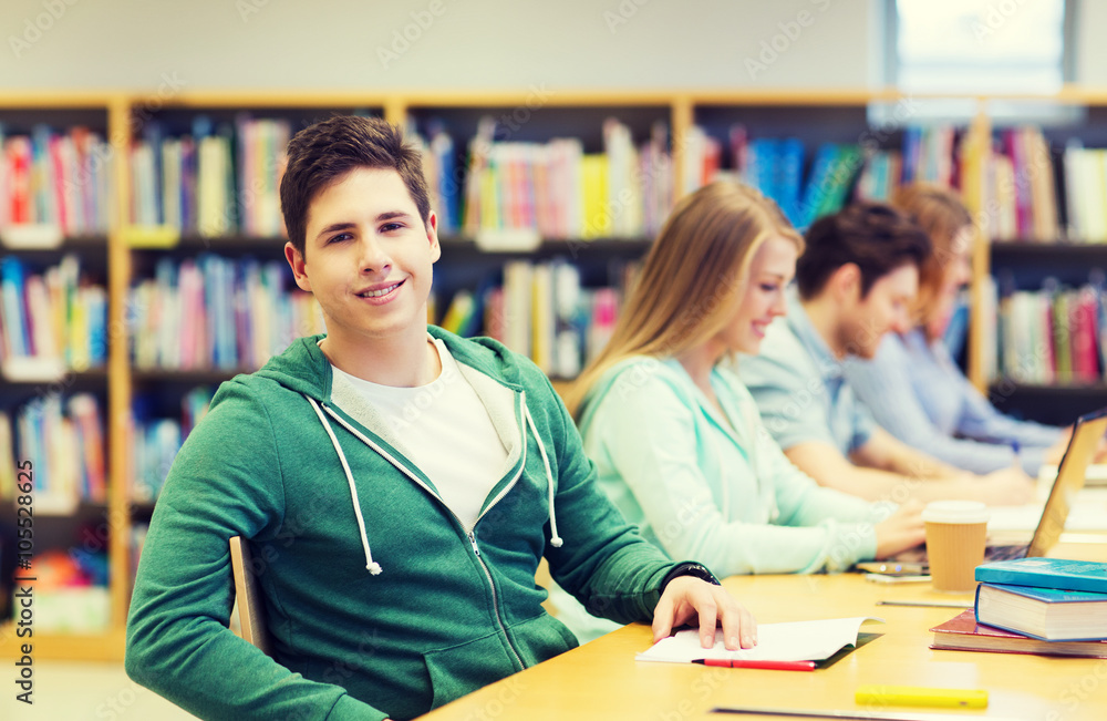 happy student boy reading books in library happy student boy reading books in library