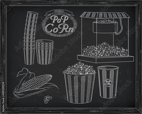 Popcorn machine, ear of corn, stack of small & big popcorn boxes