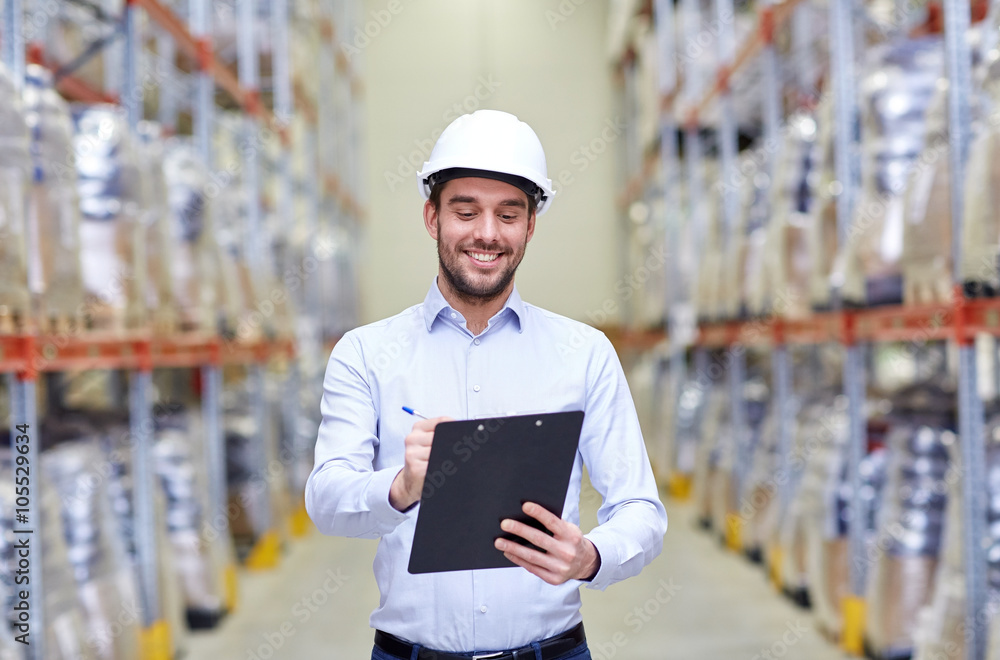 happy businessman with clipboard at warehouse happy businessman with clipboard at warehouse
