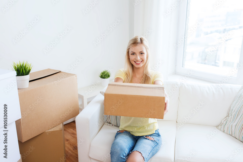 smiling young woman with cardboard box at home smiling young woman with cardboard box at home