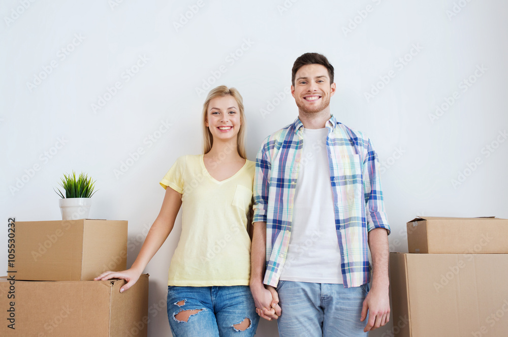 smiling couple with big boxes moving to new home smiling couple with big boxes moving to new home