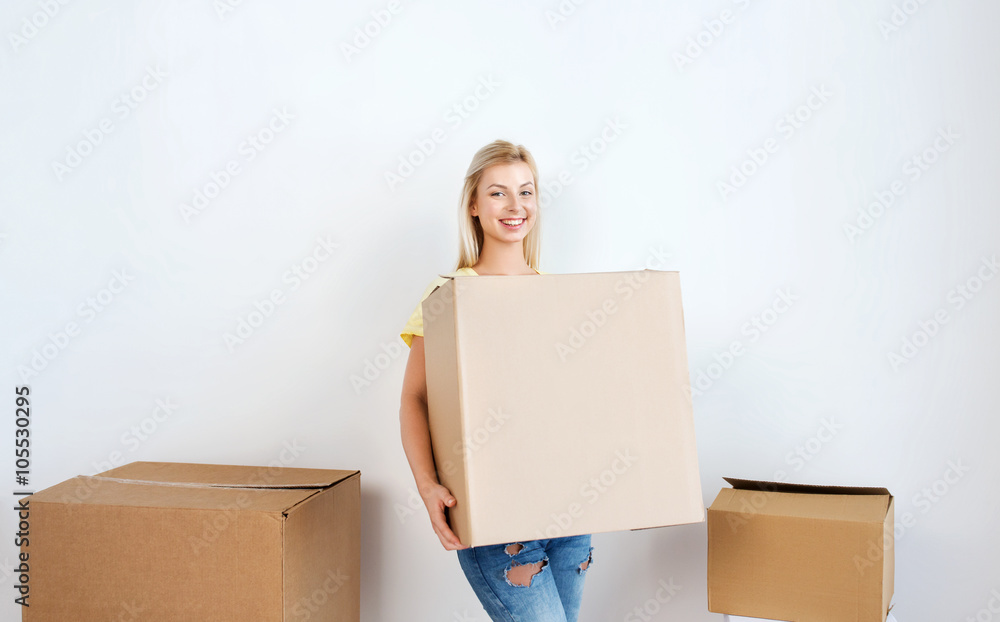 smiling young woman with cardboard box at home smiling young woman with cardboard box at home