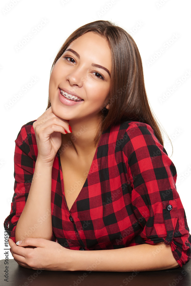 Teen female smiling with braces on her teeth