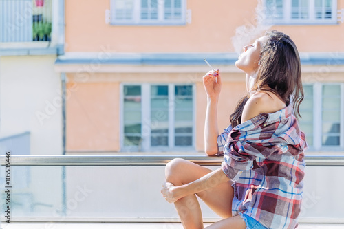 Girl smoking on the balcony