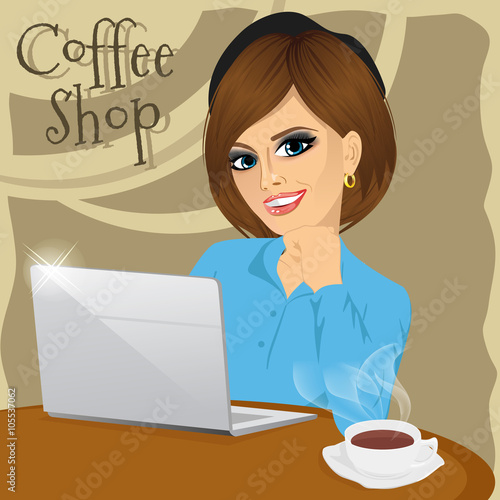 Beautiful young college student with laptop enjoying a hot coffee in coffee shop