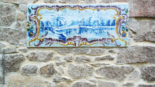 Detail of some azulejos and a stone wall