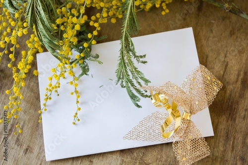 Mimosa and an empty  card with a gold bow  photo