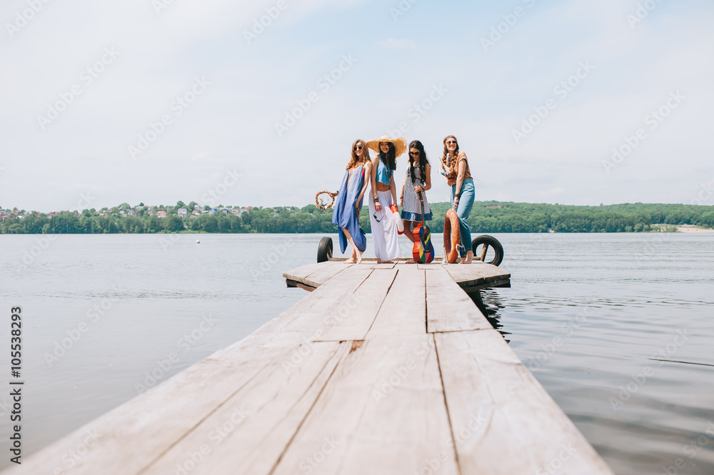 four beautiful girl friends on the dock