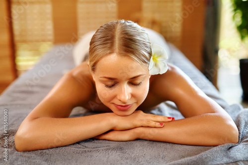 Spa Woman. Beauty Treatment. Beautiful Healthy Caucasian Girl Relaxing On Massage Table Before Procedure In The Spa Salon. Masseur Going To Massage Her Back. Body Care. Skin Care, Wellness, Wellbeing