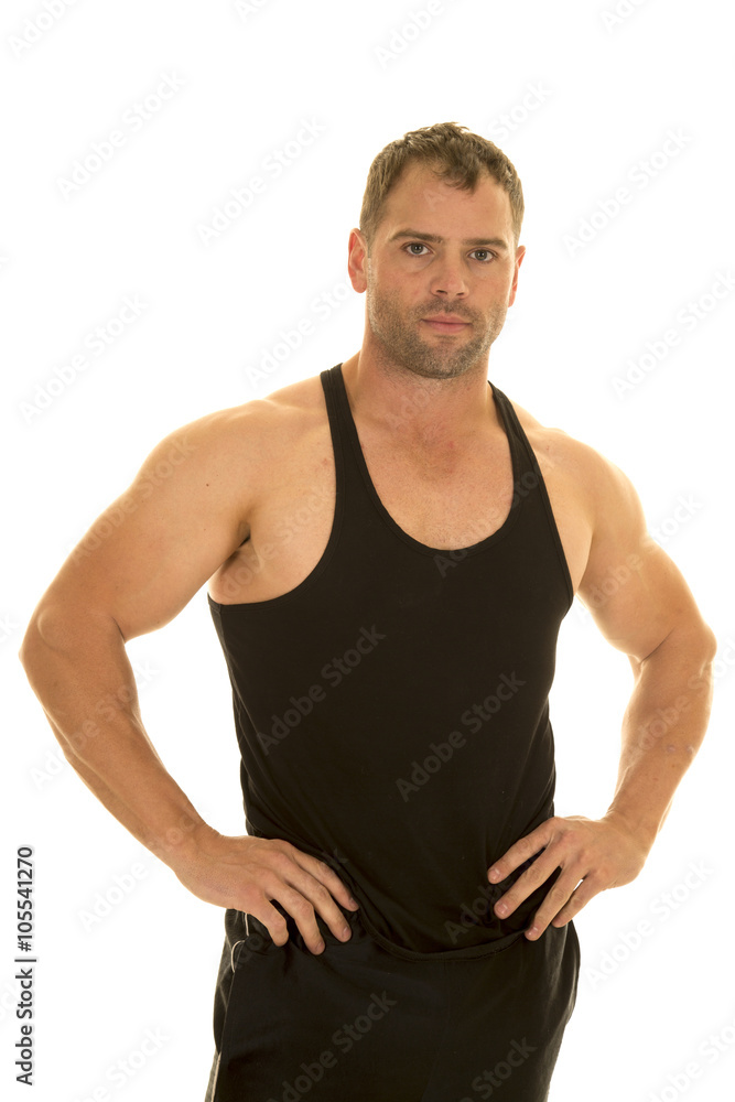 strong man in tank with hands on hips strong man in tank with hands on hips