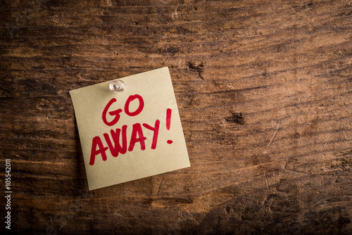 go away! - motivation paper note on wood noticeboard

