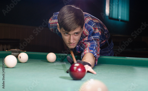 boy aiming for shot the billiard ball photo