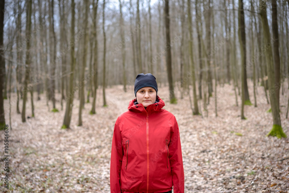 Young woman standing in middle of a forrest. Looking to camera. Young woman standing in middle of a forrest. Looking to camera.