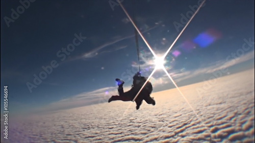 Sky diving couple jumping from the plane. Winter day.