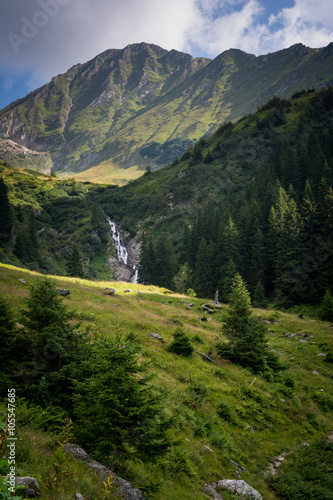 Beautiful waterfall in the scenery of green mountains in Romania
