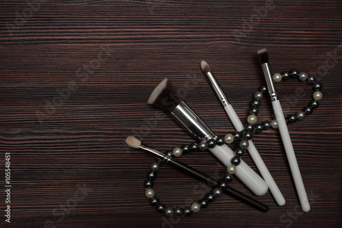 set brush and beads on a wooden background