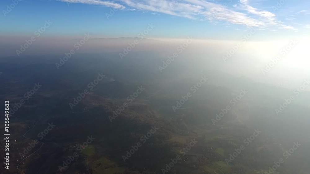 Aerial view of sunset over misty hills Aerial view of sunset over misty hills