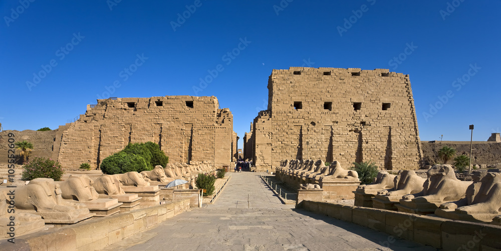 Egypt. Karnak Temple Complex - the Avenue of Sphinxes (seated with ram-headed) leads to the First Pylon