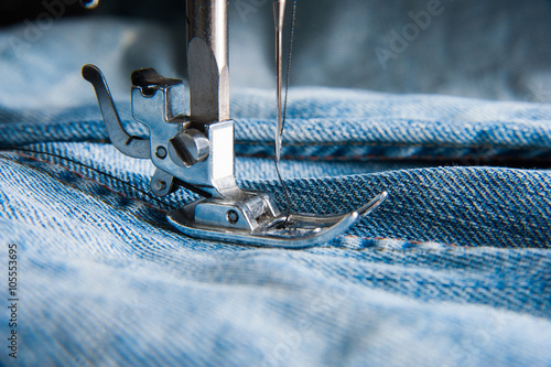 Part of sewing machine and jeans cloth photo