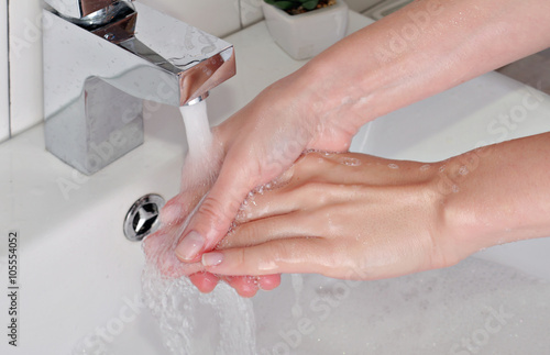 Hygiene concept. Woman washing hands close up