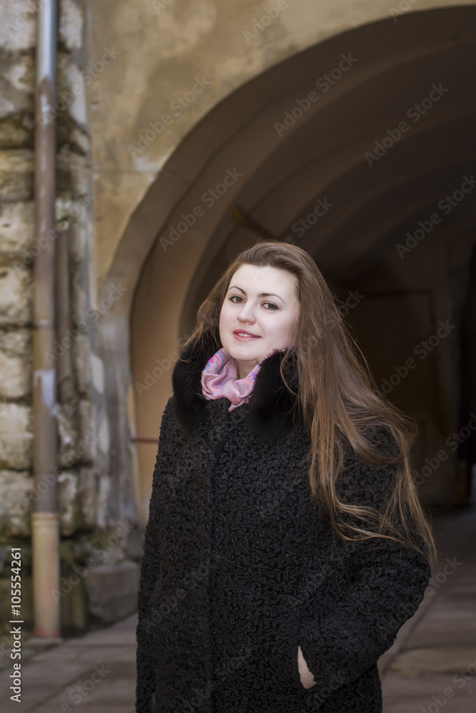 Fototapeta premium Beautiful woman with a long hair in a fur coat
