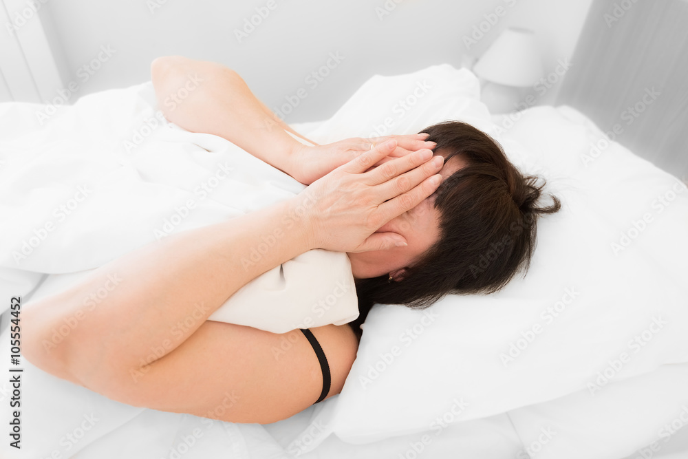 brunette woman in bed