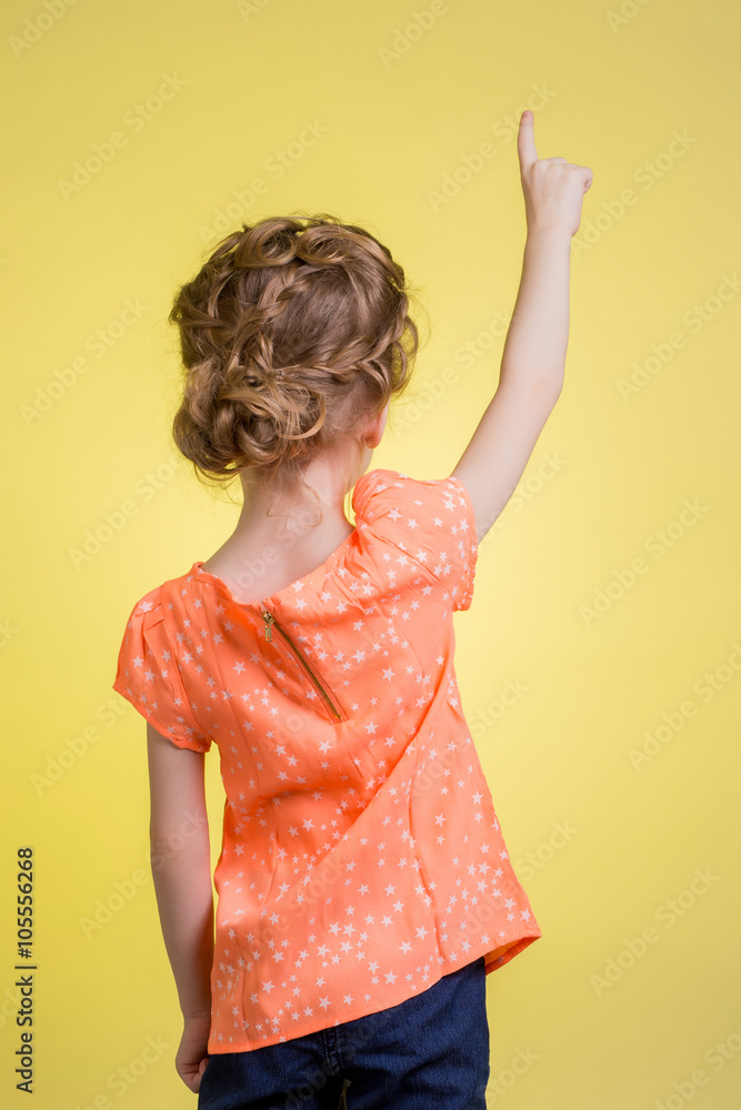teen girl pointing at copy space teen girl pointing at copy space
