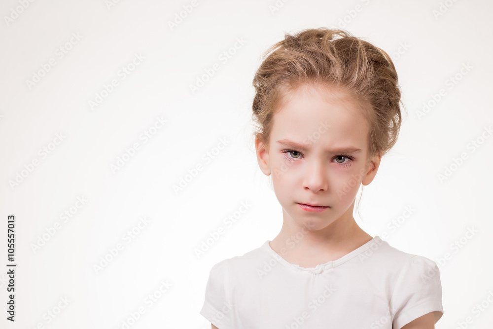 Cute teen girl angry frowns, studio portrait isolated on white background Cute teen girl angry frowns, studio portrait isolated on white background
