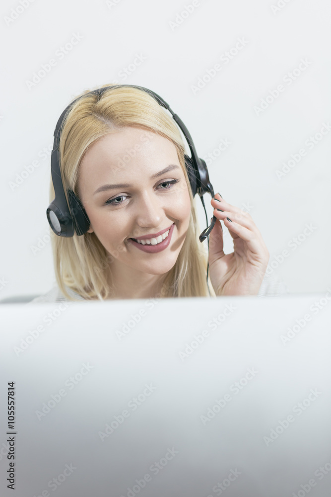 businesswoman talking on the phone while working on her computer businesswoman talking on the phone while working on her computer