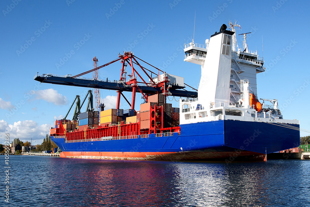 Fototapeta premium Unloading of a container ship in a container terminal in the Port of Gdansk