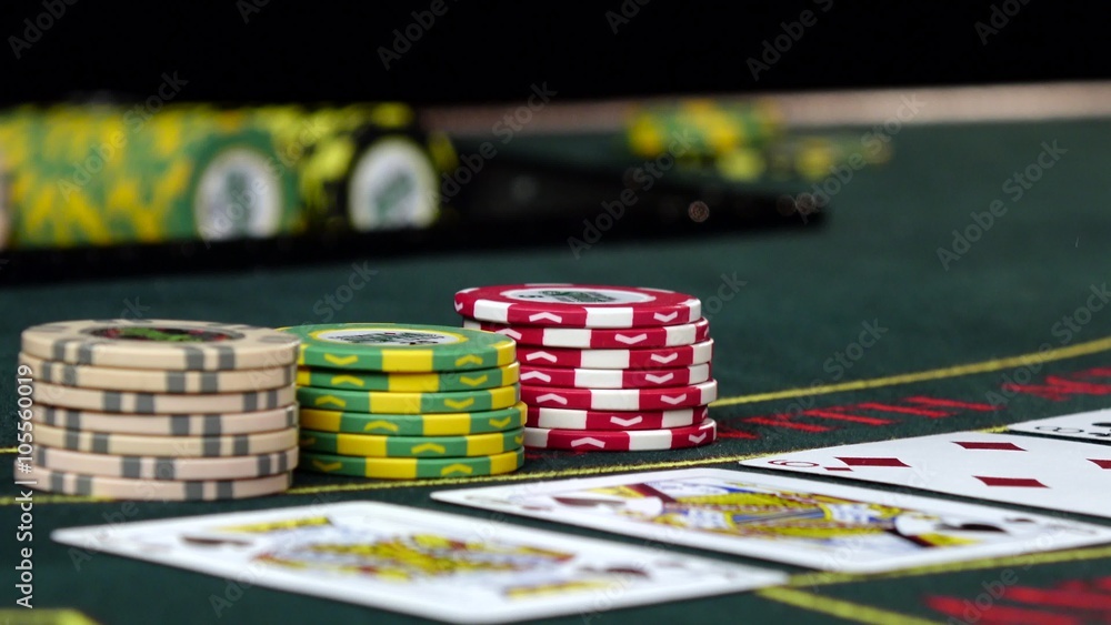 Player at casino bets his chips playing poker, close up Player at casino bets his chips playing poker, close up