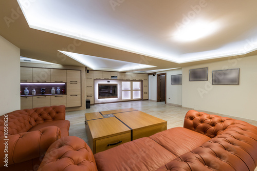 Leather sofa and wooden cofe table in livig room photo