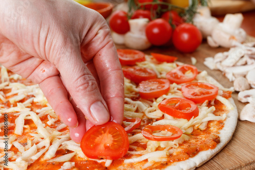 Cooking homemade pizza with...