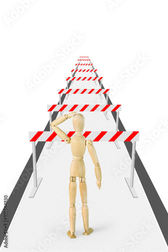 Man stands on the way with a lot of barriers. Abstract image with a wooden puppet