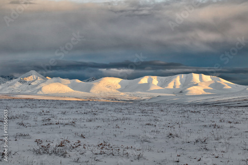 Sunset illuminating mountainsides east of the Dalton Highway photo