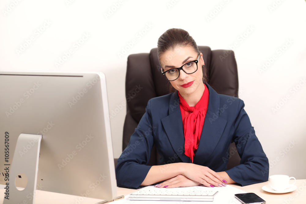 Young woman in office working on desktop Young woman in office working on desktop
