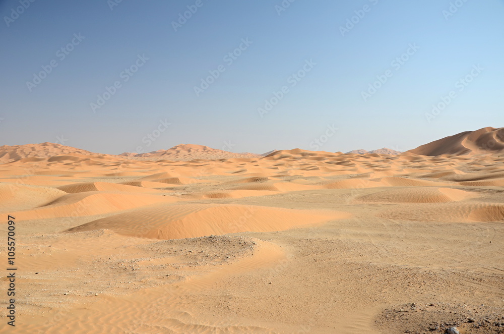 Sand dune field under blue sky sahara