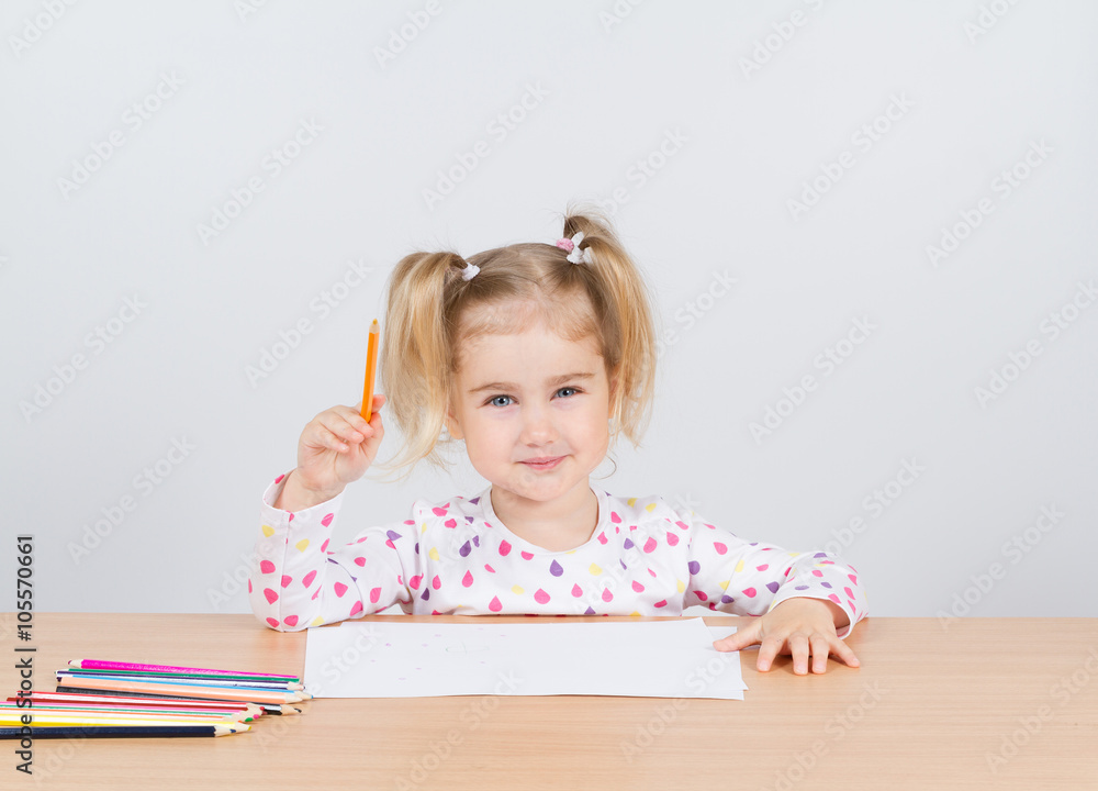 Little girl draws at table pencils. Little girl draws at table pencils.