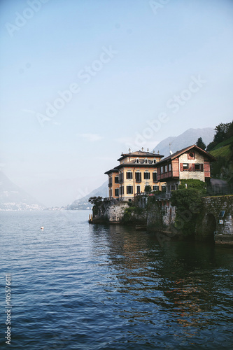 view from the water to the house on the shore of a mountain lake Como