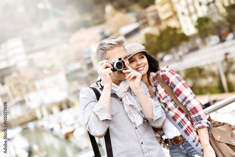 Couple of tourists taking pictures of sightseeing Couple of tourists taking pictures of sightseeing