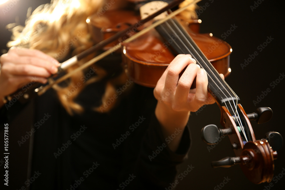 Musician plays violin on black background, close up Musician plays violin on black background, close up