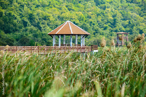 Walkway with old pavilion in lake of thailand.