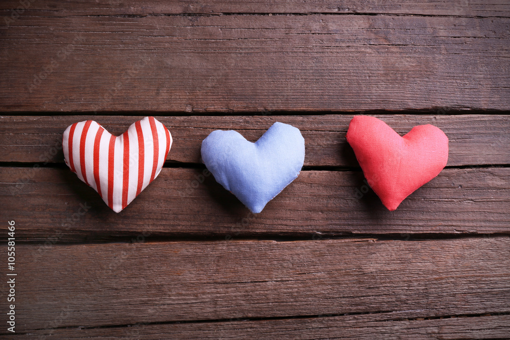Fototapeta premium Small hearts on wooden background