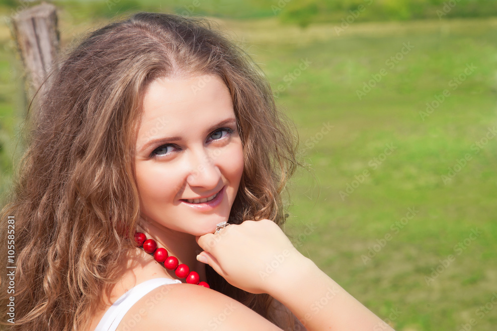 Portrait of a beautiful young woman outdoors in the summer Portrait of a beautiful young woman outdoors in the summer