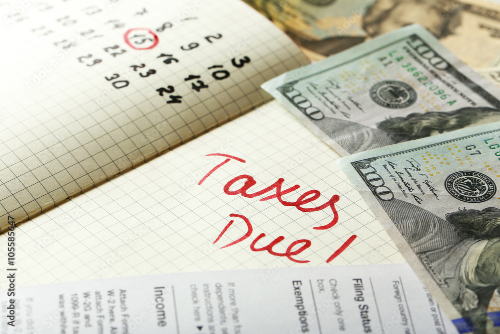 Taxes due written in a planner, close up Taxes due written in a planner, close up