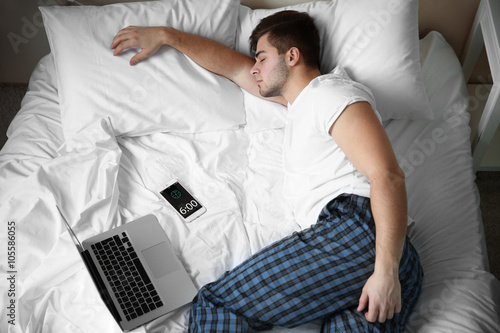 Young man sleeping with lap...
