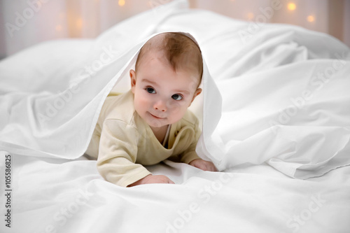 Loving baby lying under whi...