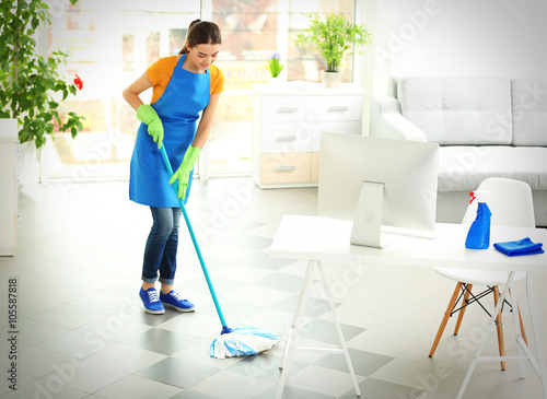 Woman cleaning floor with m...